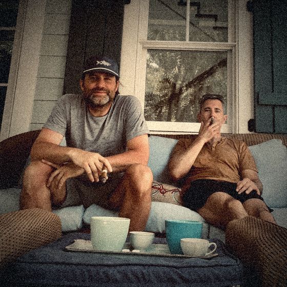 Mike and Justin on a porch with coffee